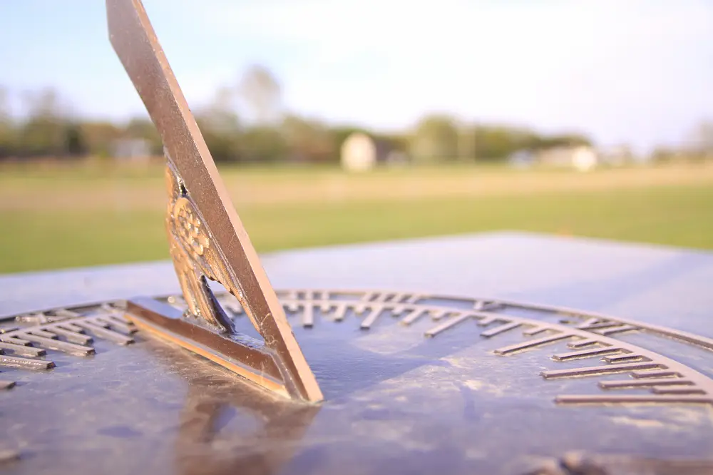 Sundial with a grassy field behind