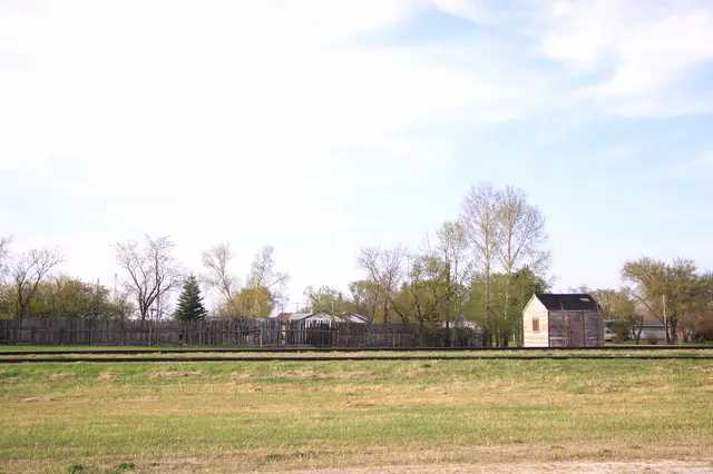 Railway tracks and small shed with fence